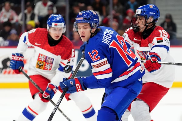 FILE - United States forward James Hagens (12) moves the puck while under pressure from Czechia forward Vojtech Cihar (15) during first-period World Junior hockey championship semifinal game action in Ottawa, Ontario, Jan. 4, 2025. (Sean Kilpatrick/The Canadian Press via AP, file)