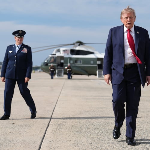 FILE - President Donald Trump, center, walks from Marine One to board Air Force One, Aug. 21, 2026, at Joint Base Andrews, Md., en route to South Carolina. (AP Photo/Jacquelyn Martin, File)
