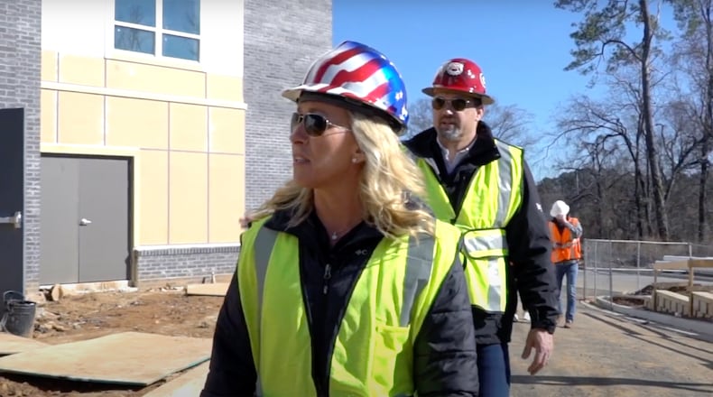 Marjorie Taylor Greene cultivated her image as a construction company owner and a conservative businesswoman in her bid for Congress. She is seen here in a campaign ad surveying a construction site with her husband, Perry, who is president of the company, Taylor Commercial, Inc. based in Alpharetta. (Campaign video image)