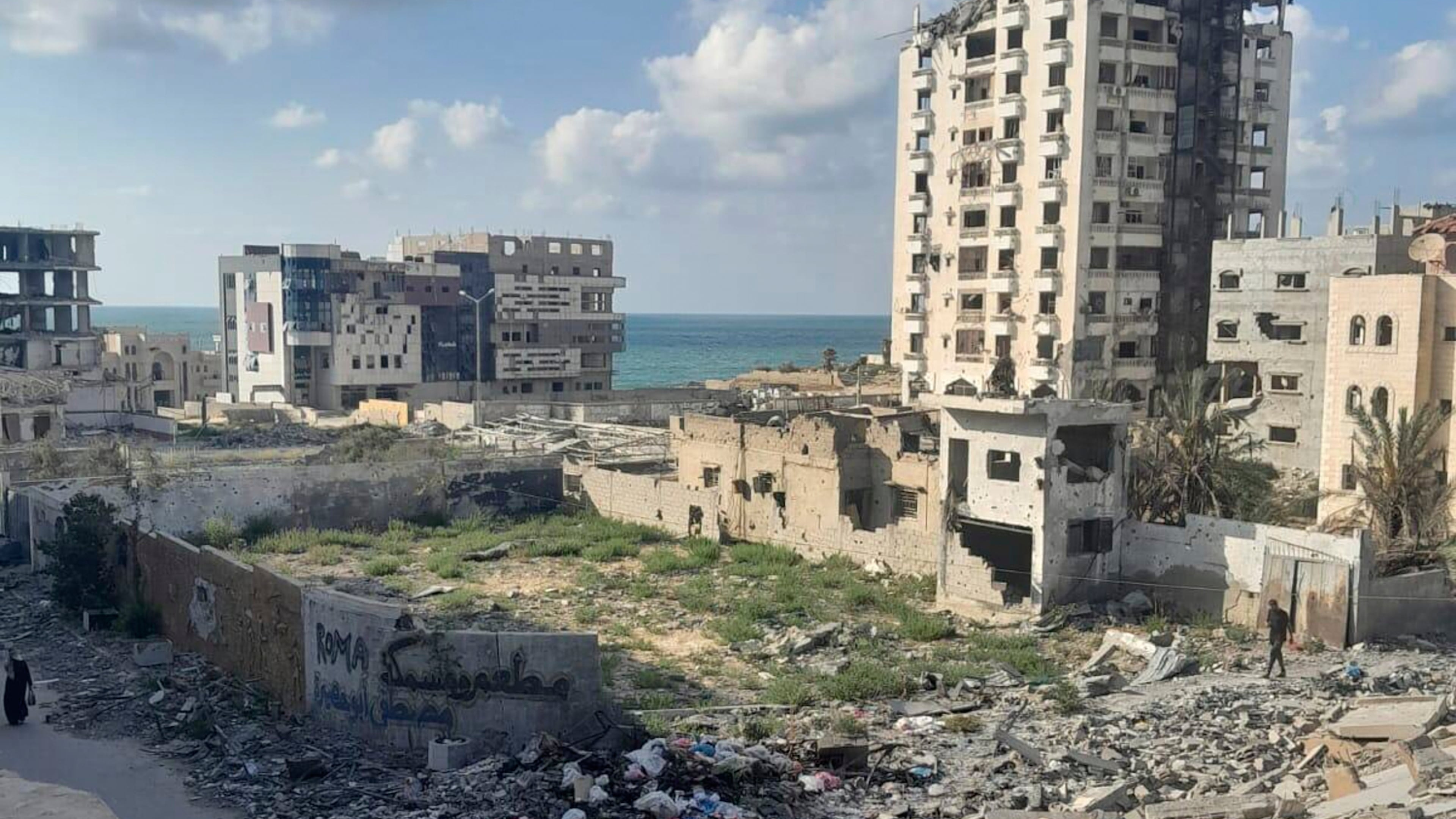 A photo taken by Noor Abu Hassira, an injured mother stranded in Gaza City as Israeli troops approach, show the destruction outside her parent's home, where she is sheltering with her three daughters in the Gaza Strip, Sunday, Sept. 21, 2025 (Noor Abu Hassira via AP)