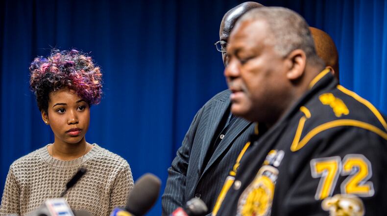 Bridget Anderson (left), the girlfriend of Anthony Hill, listens as Amos King with the Justice for Veterans organization speaks after the DeKalb County District Attorney announced that his office will be seeking a grand jury indictment for Robert Olsen. JONATHAN PHILLIPS / SPECIAL