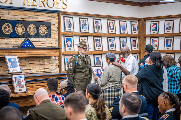 Soldiers, family members, and friends gather to honor fallen heroes at the Hall of Heroes photo mounting ceremony at the Survivor Outreach Services Center at Fort Moore on Feb. 07, 2025. Photos mounted include those of Pfc. Keon Wiliams, Staff Sgt. William J. Rivers, Sgt. 1st Class Alwyn C. Cashe and Master Sgt. Cheryl B. Harmon. (Patrick A. Albright/U.S. Army)