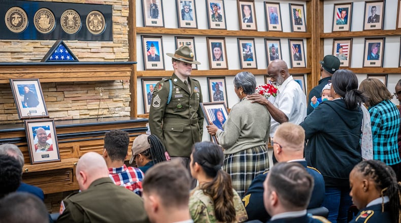 Soldiers, family members, and friends gather to honor fallen heroes at the Hall of Heroes photo mounting ceremony at the Survivor Outreach Services Center at Fort Moore on Feb. 07, 2025. Photos mounted include those of Pfc. Keon Wiliams, Staff Sgt. William J. Rivers, Sgt. 1st Class Alwyn C. Cashe and Master Sgt. Cheryl B. Harmon. (Patrick A. Albright/U.S. Army)