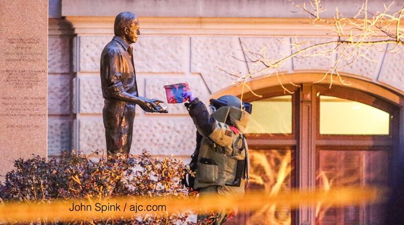 Suspicious content was found on a statue of former President Jimmy Carter on March 13. JOHN SPINK / JSPINK@AJC.COM