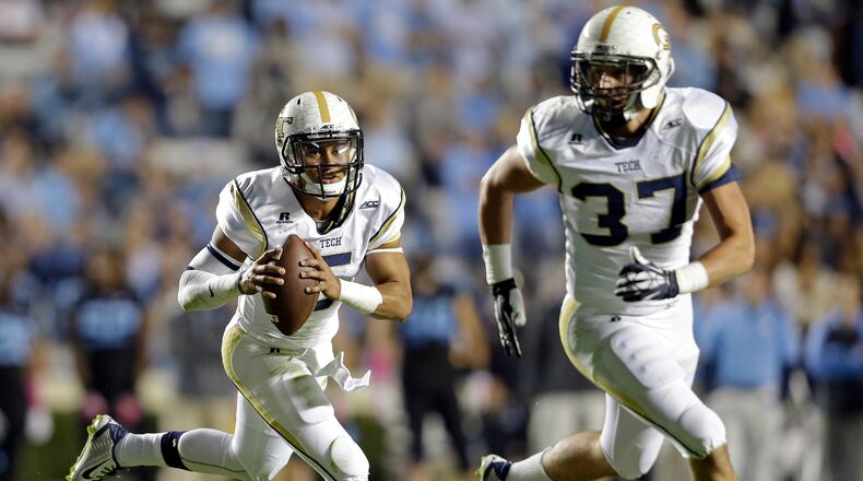 Georgia Tech quarterback Justin Thomas (5) rolls out as Zach Laskey (37) blocks during the first half of an NCAA college football game against North Carolina in Chapel Hill, N.C., Saturday, Oct. 18, 2014. (AP Photo/Gerry Broome)