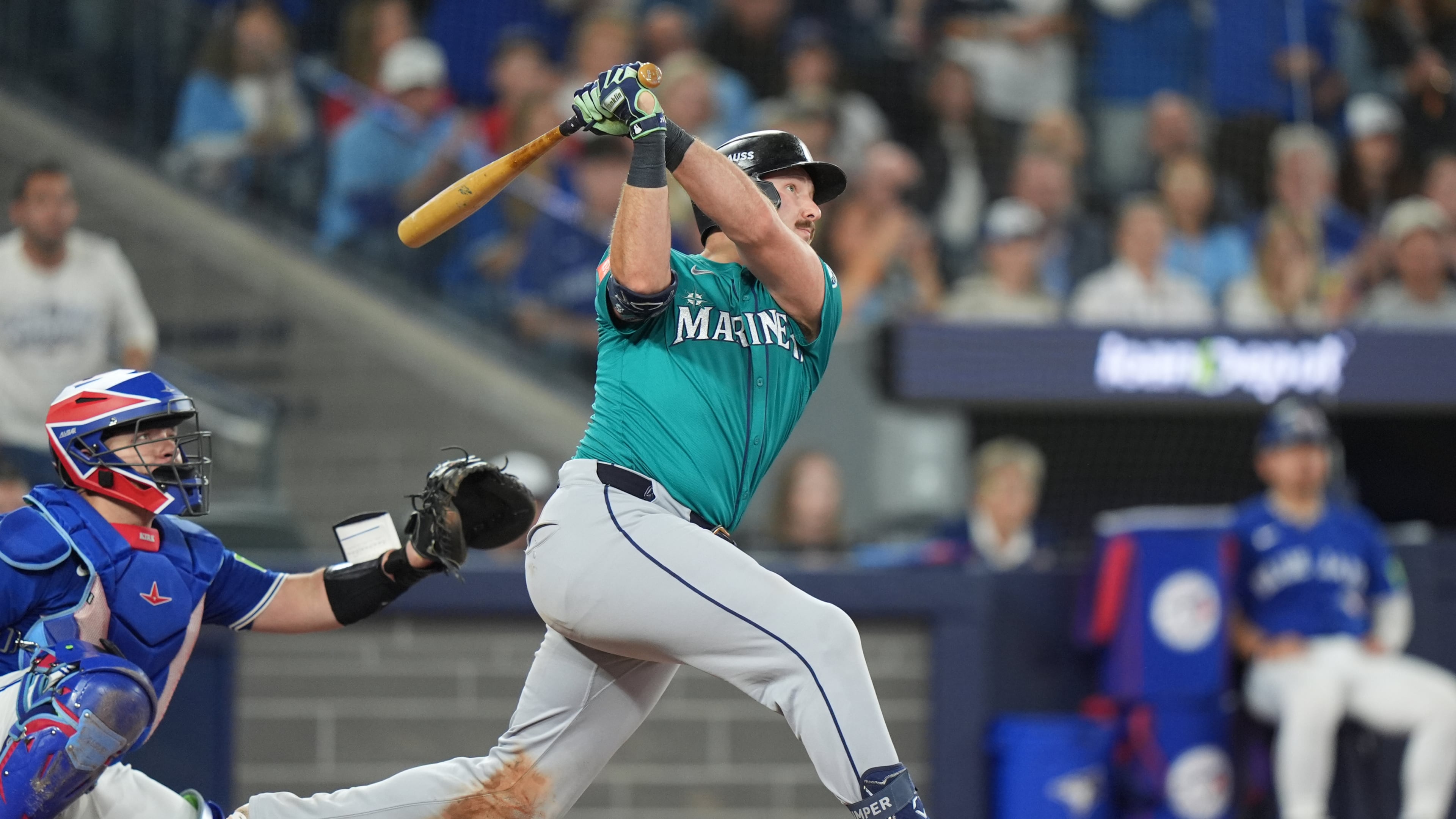 Seattle Mariners' Cal Raleigh (29) hits a home run in front of Toronto Blue Jays catcher Alejandro Kirk (30) sixth inning American League Championship Series baseball action in Toronto on Sunday, Oct. 12, 2025. (Frank Gunn/The Canadian Press via AP)
