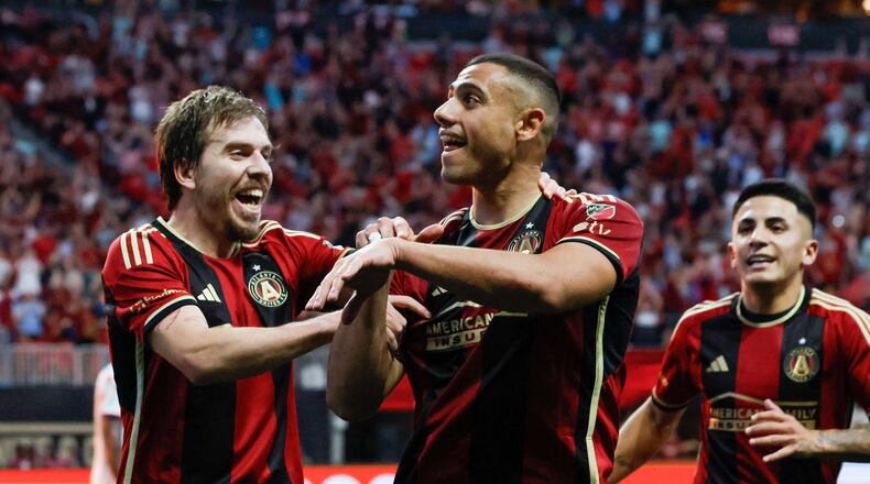 Atlanta United forward Giorgos Giakoumakis (7) signals the crows as he celebrates with midfielder Saba Lobzhanidze (9) after scoring the first goal of his team during the first half against the Chicago Fire at Mercedes-Benz Stadium on Sunday, March 31, 2024.  Miguel Martinez / miguel.martinezjimenez@ajc.com