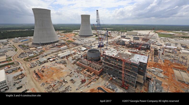 The cooling towers for Plant Vogtle reactors 3 and 4 rise above the construction sites. GEORGIA POWER