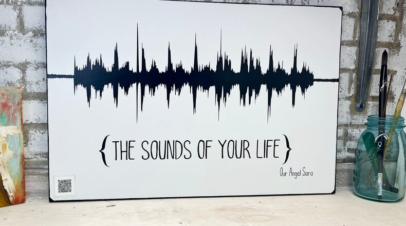 The soundwave image is created from an audio or video file sent to the artist.  The “magic” is the QR code that plays back the original message or sound.