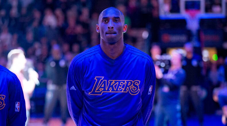 Los Angeles Lakers forward Kobe Bryant (24) looks on during the national anthem before a game against the Minnesota Timberwolves at Target Center.