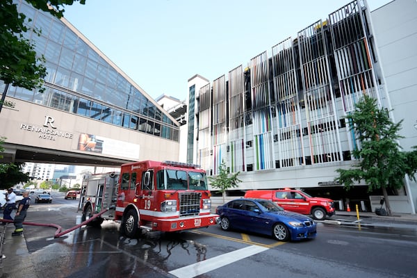 A fire truck is seen outside a parking garage where vehicles caught fire and part of a floor in the structure collapsed Tuesday, June 10, 2025, in Nashville, Tenn. (AP Photo/George Walker IV)