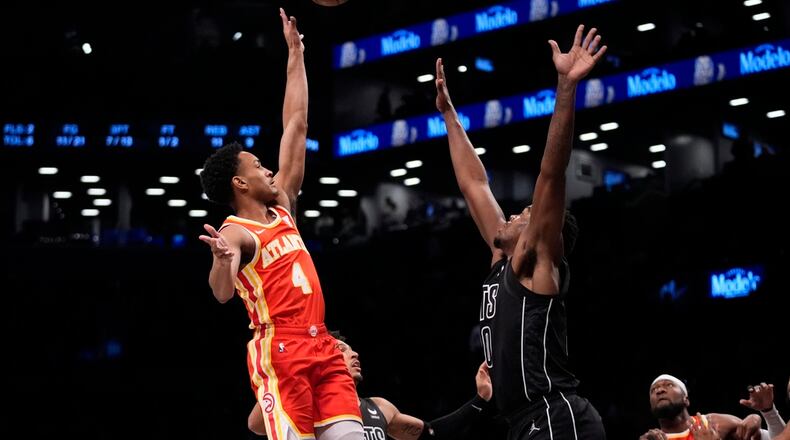 Atlanta Hawks' Kobe Bufkin (4) shoots over Brooklyn Nets' Day'Ron Sharpe (20) during the first half of an NBA basketball game Thursday, Feb. 29, 2024, in New York. (AP Photo/Frank Franklin II)