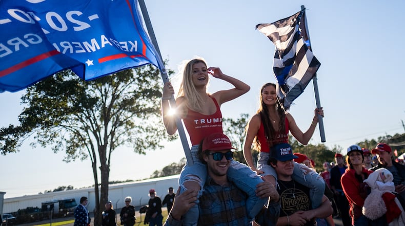 Kayden Ammerall, left, rides on Bryce Kaufman’s shoulders as Lauren Kaufman rides on Jeremiah Angel’s shoulders as they make their way toward the airport in Rome on Sunday afternoon for President Donald Trump's campaign rally. (Photo: Ben Gray for The Atlanta Journal-Constitution)