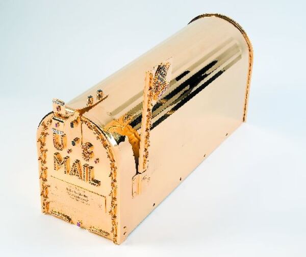 San Francisco jewelry artist Sidney Mobell created this U.S. mail box, plated with 24-karat gold and studded with 137 sapphires weighing 48.20 carats, 100 rubies weighing 24.50 carats, 25 diamonds weighing 2.25 carats, and 10 emeralds weighing 1.75 carats. It's on view in the exhibit "Jeweled Objects of Desire at Cartersville's Tellus Science Center.