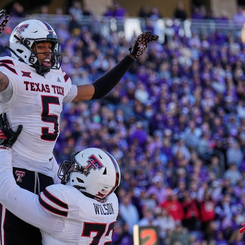 Texas Tech wide receiver Caleb Douglas (5) celebrates with offensive lineman Sheridan Wilson after scoring a touchdown during the second half of an NCAA college football game against Kansas State, Saturday, Nov. 1, 2025, in Manhattan, Kan. (AP Photo/Charlie Riedel)
