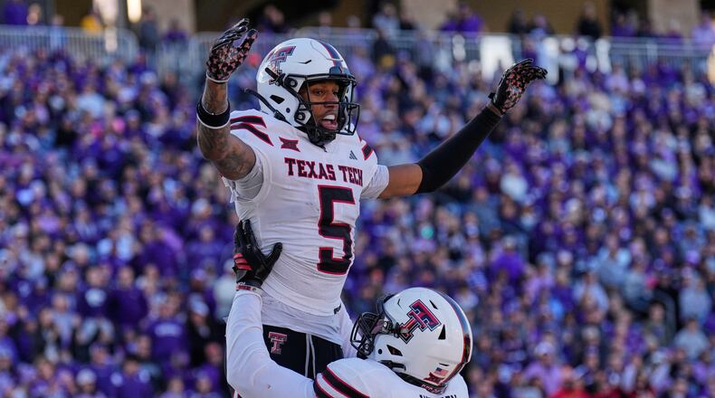 Texas Tech wide receiver Caleb Douglas (5) celebrates with offensive lineman Sheridan Wilson after scoring a touchdown during the second half of an NCAA college football game against Kansas State, Saturday, Nov. 1, 2025, in Manhattan, Kan. (AP Photo/Charlie Riedel)