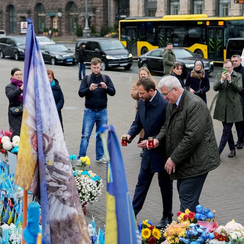 Ukraine's Foreign Minister Andrii Sybiha and Estonia's Minister of Foreign Affairs Margus Tsahkna place candles at a memorial for fallen Ukrainian soldiers in Independence Square, Monday, Oct. 27, 2025, in Kyiv, Ukraine. (AP Photo/Julia Demaree Nikhinson)