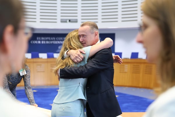 René Lefeber, right, deputy Legal Adviser of the Minister of Foreign Affairs of the Kingdom of the Netherlands, hugs agent to the European Court of Human Rights for Netherlands Babette Koopman after the European Court of Human Rights issued its judgment on Russian violations in Ukraine since 2014, including the downing of Malaysia Airlines flight MH17, Wednesday, July 9, 2025 in Strasbourg, eastern France. (AP Photo/Antonin Utz)