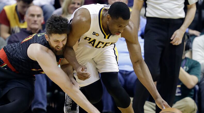 Atlanta Hawks’ Ryan Kelly, left, and Indiana Pacers’ Thaddeus Young vie for a loose ball during the first half of an NBA basketball game Wednesday, April 12, 2017, in Indianapolis. (AP Photo/Darron Cummings)