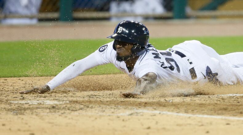 The Detroit Tigers' Travis Demeritte scores from third base on a wild pitch by Nate Jones of the Cincinnati Reds during the seventh inning at Comerica Park in Detroit on Friday, July 31, 2020. The Tigers won, 7-2. (Duane Burleson/Getty Images/TNS)