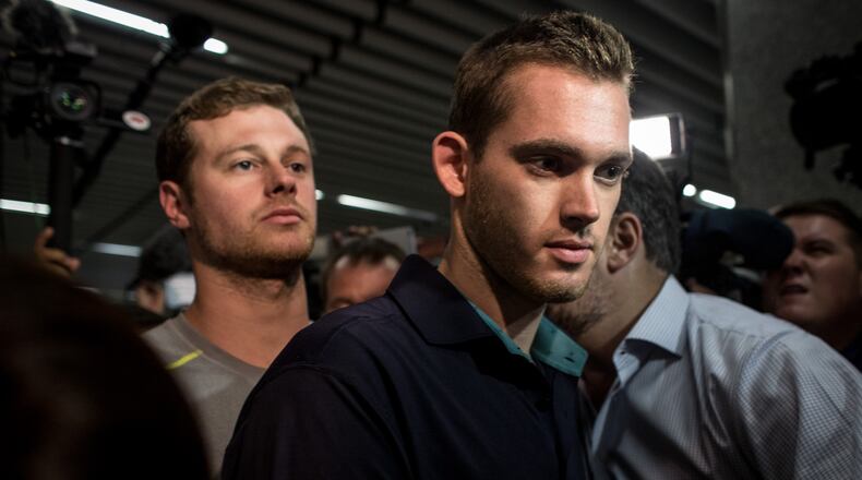 RIO DE JANEIRO, BRAZIL - AUGUST 18: U.S Olympic swimmers Gunnar Bentz and Jack Conger leave the police headquarters at International departures of Rio de Janiero's Galeo International airport on August 18, 2016 in Rio de Janiero, Brazil. The swimmers were removed from their flight departing for the United States by Brazilian authorities to give more information about a reported armed robbery earlier in the week which included fellow U.S swimmers Ryan Lochte and James Feign. (Photo by Chris McGrath/Getty Images)