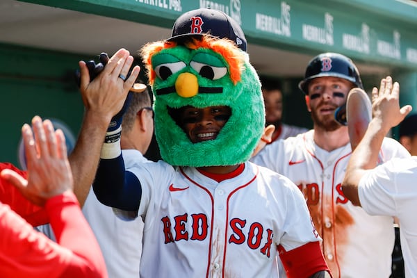 Boston Red Sox's Ceddanne Rafaela wears a "Wally the Green Monster" mask after hitting a two run homer in the sixth inning of a baseball game, Sunday, July 13, 2025, in Boston. (AP Photo/Greg M. Cooper)