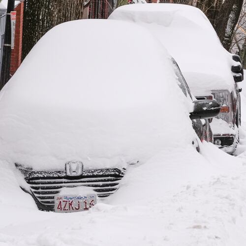 A man digs a car out of the snow on Beacon Hill following a winter storm that dumped more than a foot of snow across the region, Monday, Jan. 26, 2026, in Boston. (AP Photo/Charles Krupa)