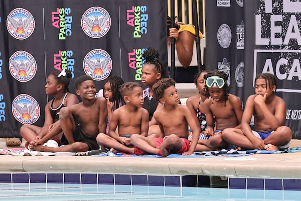 Kids sit by the Rosa L. Burney Park Swimming Pool in Atlanta on Wednesday.  (Natrice Miller/AJC)