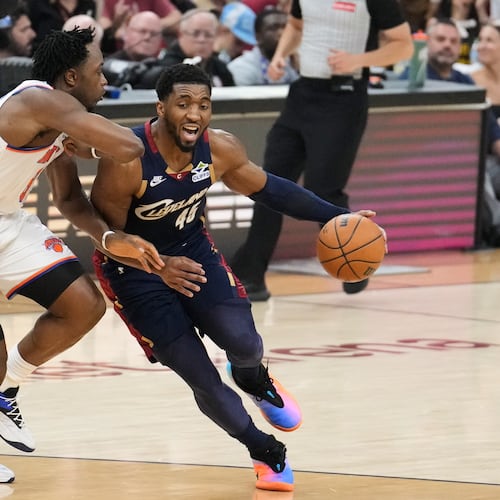 New York Knicks forward Og Anunoby (8) defense against Cleveland Cavaliers guard Donovan Mitchell (45) during the first half of Game 4 in the Eastern Conference finals NBA basketball playoffs series in Cleveland, Monday, May 25, 2026. (AP Photo/Sue Ogrocki)