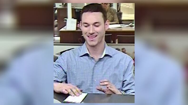 Surveillance cameras captured this photo of a man who allegedly took $25,000 from another person's bank accounts in Hall County.