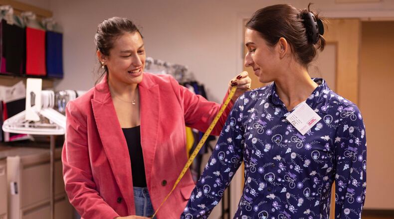 Hannah Bowerman, left, a technical designer for Terry Precision Cycling, measures a bike shirt worn by market designer Thea Sousa during a fit session at the company’s headquarters in Burlington, Vt., Tuesday, Oct. 28, 2025. (AP Photo/Amanda Swinhart)