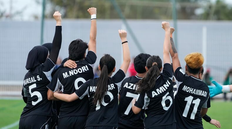 Members of Afghan Women United soccer team celebrate after scoring a goal against Chad, in their first international tournament since fleeing their country, in Casablanca, Morocco, Sunday, Oct. 26, 2025. (AP Photo/Mosa'ab Elshamy)