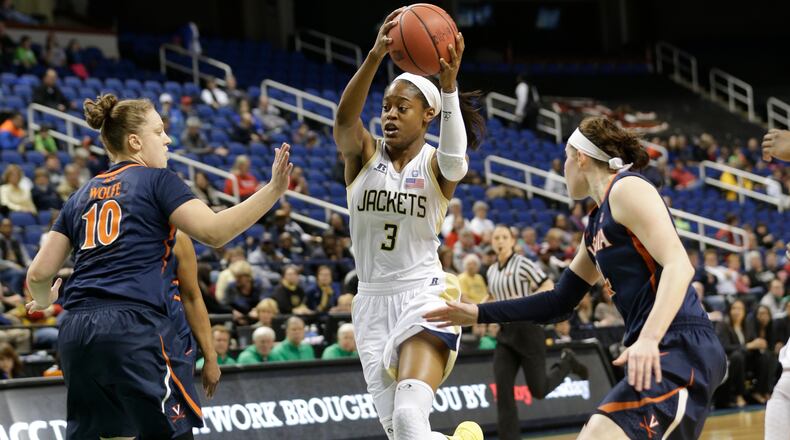 Georgia Tech's Kaela Davis (3) drives between Virginia's Kelsey Wolfe (10) and Lexie Gerson (14) during the first half of an NCAA college basketball game at the Atlantic Coast Conference tournament in Greensboro, N.C., Thursday, March 6, 2014. (AP Photo/Chuck Burton)