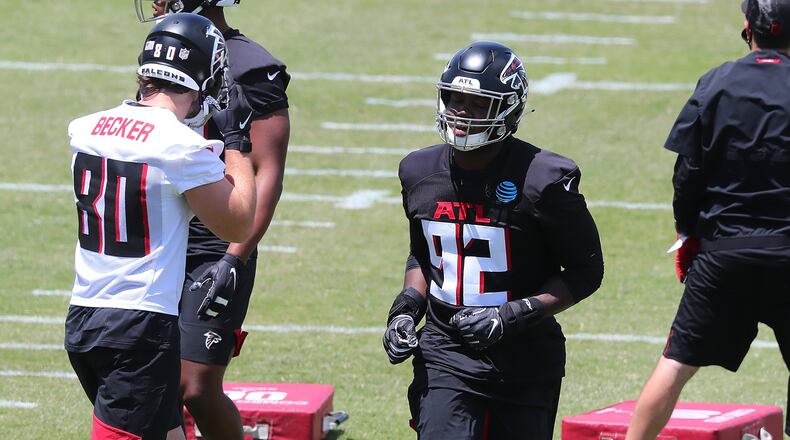 Falcons outside linebacker Ade Ogundeji (center) sprints to the next drill during rookie minicamp Friday, May 14, 2021, in Flowery Branch.  (Curtis Compton / Curtis.Compton@ajc.com)