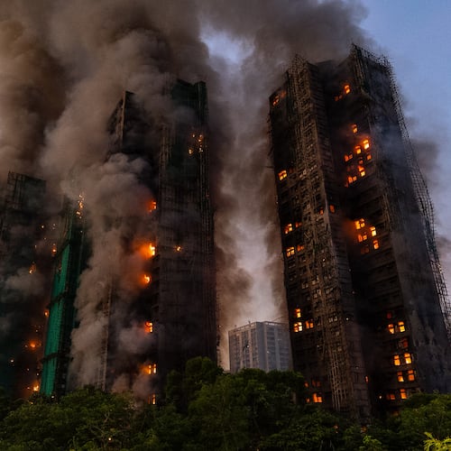 FILE - Smoke rises after a fire broke out at Wang Fuk Court, a residential estate in the Tai Po district of Hong Kong's New Territories, Nov. 26 2025. (AP Photo/Chan Long Hei, File)