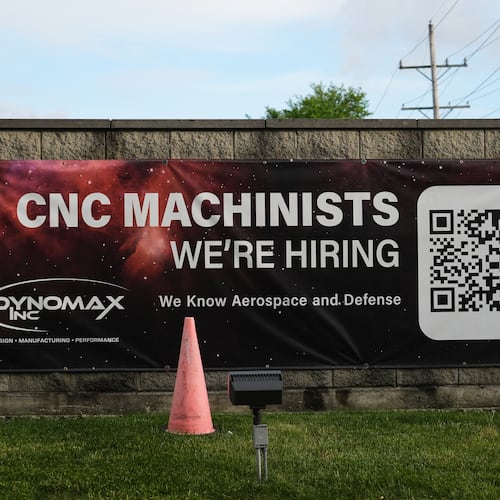 A hiring sign is seen outside of a company in Wheeling, Ill., Monday, June 8, 2026. (AP Photo/Nam Y. Huh)
