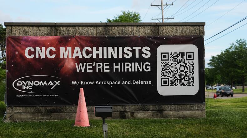 A hiring sign is seen outside of a company in Wheeling, Ill., Monday, June 8, 2026. (AP Photo/Nam Y. Huh)
