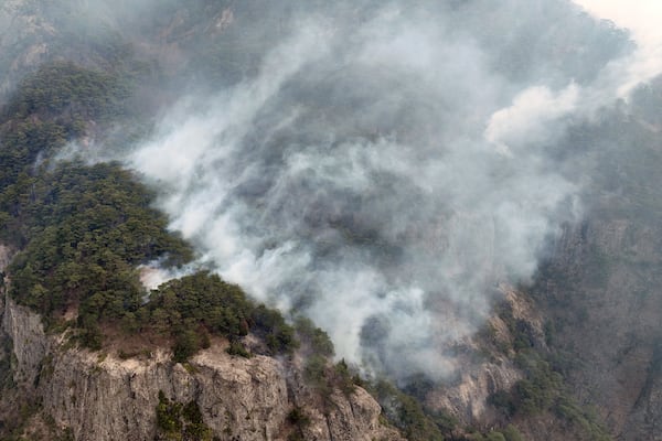 Smoke rises from a wildfire at a national park in Cheongsong, South Korea, Thursday, March 27, 2025. (Lee Moo-yeol/Newsis via AP)