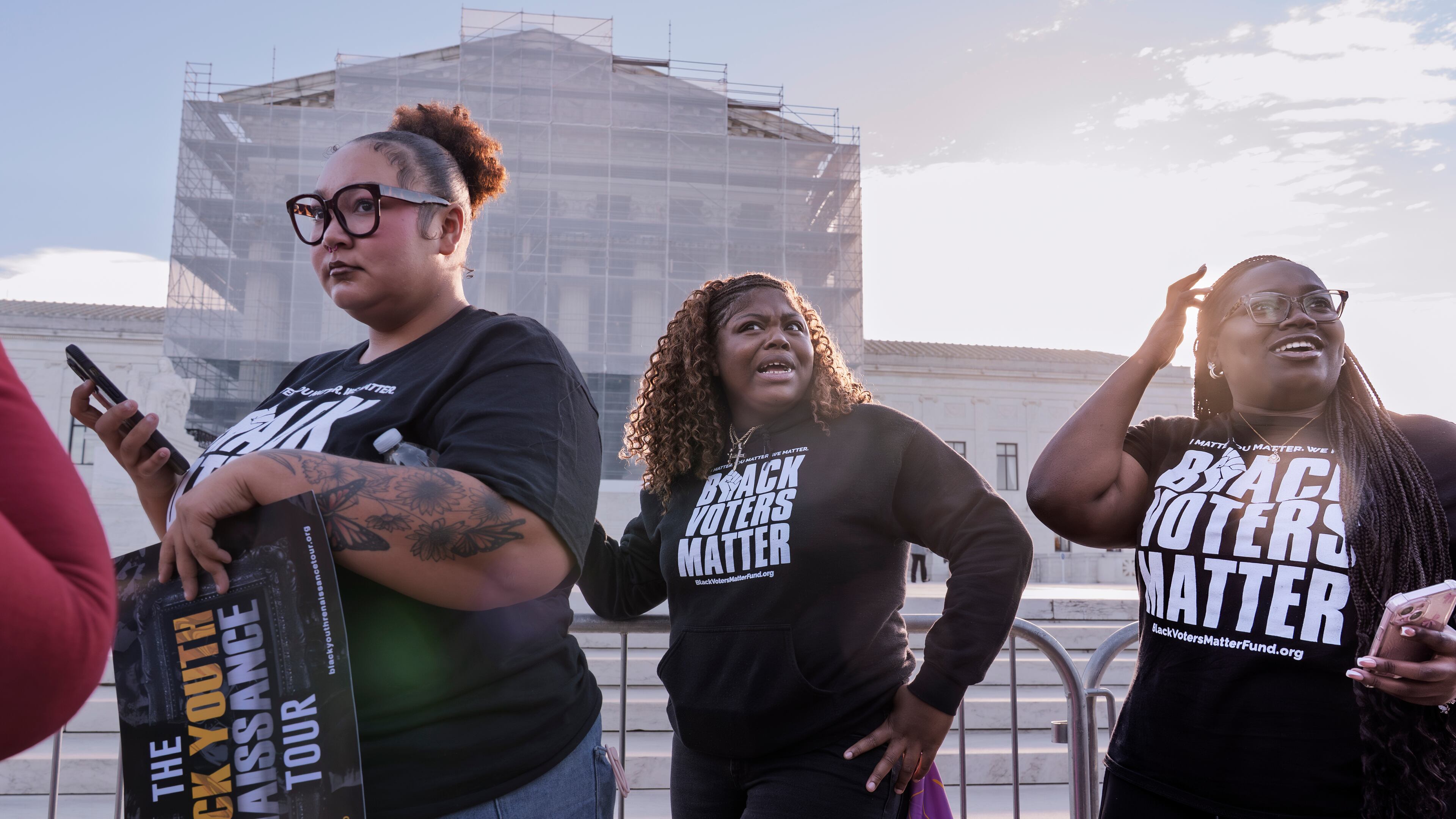 Voting rights activists gather outside the Supreme Court in Washington, early Wednesday, Oct. 15, 2025, as the justices prepare to take up a major Republican-led challenge to the Voting Rights Act, the centerpiece legislation of the Civil Rights Movement. (AP Photo/J. Scott Applewhite)