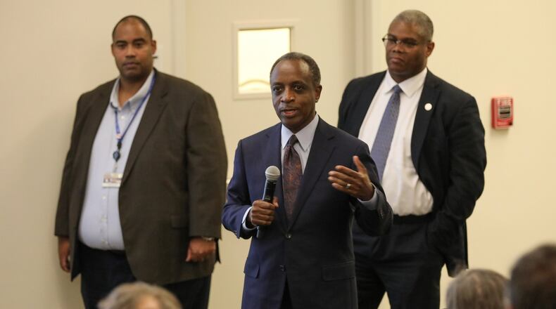 DeKalb CEO Michael Thurmond (center) and officials from the Department of Watershed Management talk to residents of Decatur, Ga. He presented the plans of an upcoming project to rectify sewer spill issues near Oakhurst on Tuesday, March 10, 2020. MIGUEL MARTINEZ FOR THE ATLANTA JOURNAL-CONSTITUTION
