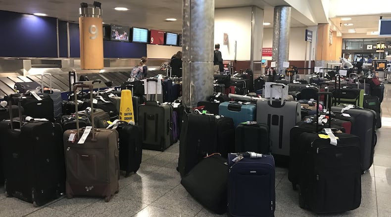 Hundreds of bags were left on the floor at Delta baggage claim at the Atlanta airport in the aftermath of the airline’s flight cancellations last week. (Kelly Yamanouchi, The Atlanta Journal-Constitution)