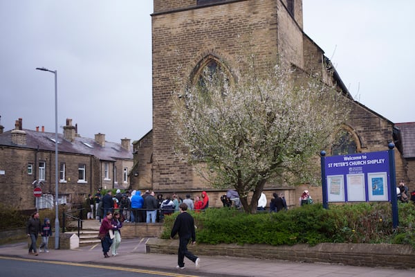 Spectators queue outside St Peter's Church in Shipley before one of the Kingdom Wrestling's monthly wrestling shows, Saturday, March 29, 2025. (AP Photo/Jon Super)