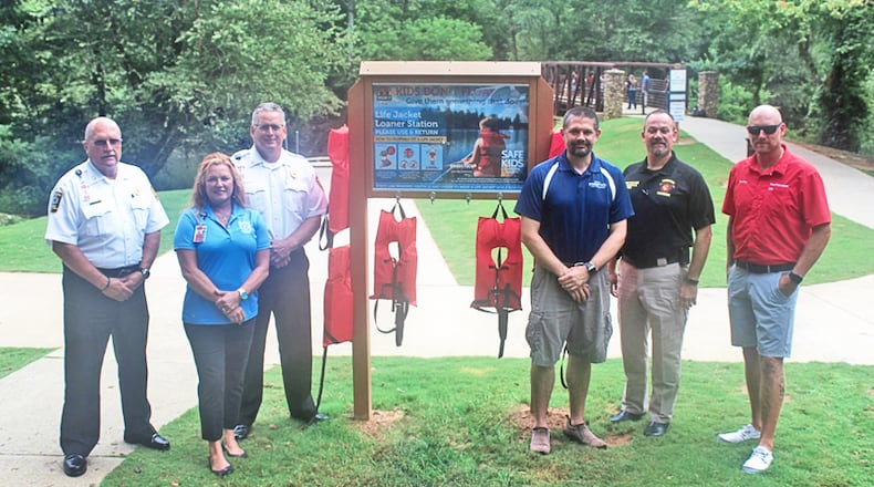 Attending the dedication of a life jacket loaner station at Olde Rope Mill Park are (from left) Cherokee County Fire Chief Tim Prather; Lisa Grisham, senior fire and life educator; Cherokee Assistant Fire Chief Eddie Robinson; Michael D. Huffstetler, Woodstock Parks and Recreation director; Sgt. George Williams, Woodstock Fire & Rescue; and Chris Day, Tow Boat US and BoatUS Foundation.