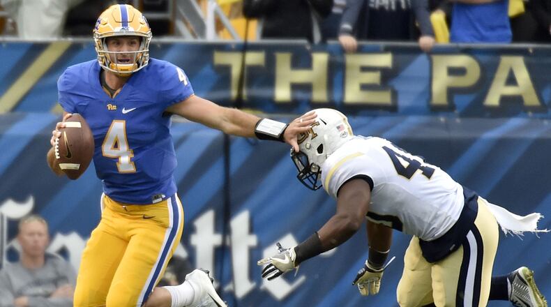 Pitt quarterback Nate Peterman, left, pushes away Georgia Tech's P.J. Davis in the first quarter on Saturday, Oct. 8, 2016, at Heinz Field in Pittsburgh. Pitt won, 37-34. (Matt Freed/Pittsburgh Post-Gazette/TNS)