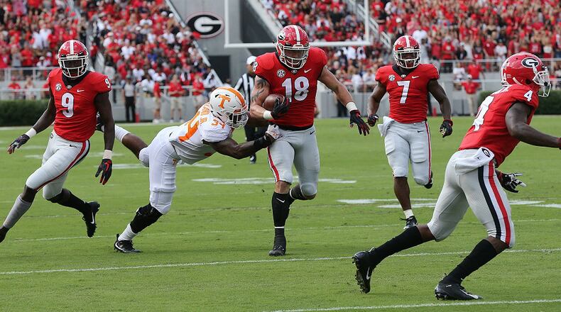 Georgia tight end Isaac Nauta recovers a Jake Fromm fumble and returns it past Tennessee linebacker Darrin Kirkland for a touchdown Saturday, Sept 29, 2018, in Athens. Curtis Compton/ccompton@ajc.com