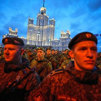 Russian servicemen prepare to march towards Red Square prior to the Victory Day military parade rehearsal in Moscow, Wednesday, April 29, 2026, backdropped by a Stalin stile skyscraper. (AP Photo/Alexander Zemlianichenko)