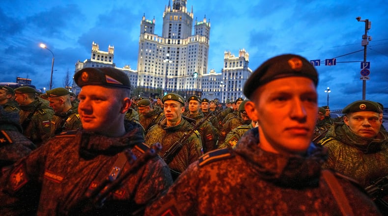 Russian servicemen prepare to march towards Red Square prior to the Victory Day military parade rehearsal in Moscow, Wednesday, April 29, 2026, backdropped by a Stalin stile skyscraper. (AP Photo/Alexander Zemlianichenko)