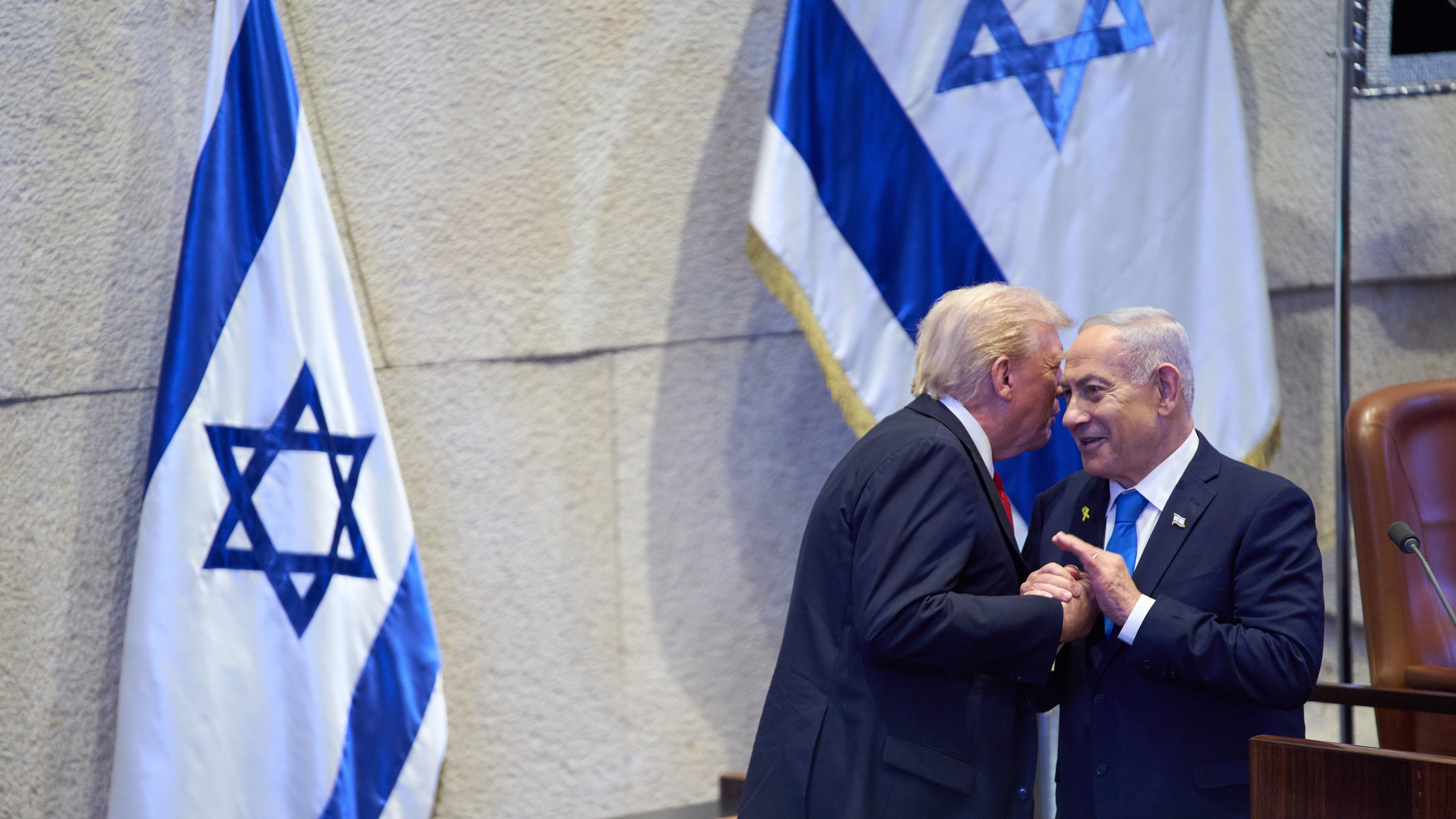President Donald Trump talks with Israel's Prime Minister Benjamin Netanyahu at the Knesset, Israel's parliament, Monday, Oct. 13, 2025, in Jerusalem. (AP Photo/Evan Vucci, Pool)