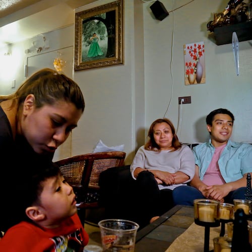 FILE PHOTO - Rosa, second from right, who wants her last name withheld, an undocumented immigrant who used to get about $190 per month from the Supplemental Nutrition Assistance Program, or SNAP, and who stopped taking benefits fearing deportation, is surrounded by her son Edgar, far right, daughter Olga, far left, and grandson Logan at their home during an interview in New York, May 17, 2017. (AP Photo/Bebeto Matthews, File)