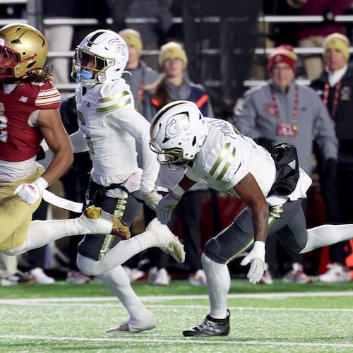 Boston College running back Turbo Richard, left, runs for a touchdown as Georgia Tech defensive backs Rodney Shelley, center, and Clayton Powell-Lee, right, pursue during the second half of an NCAA college football game Saturday, Nov. 15, 2025, in Boston. (Mark Stockwell/AP)